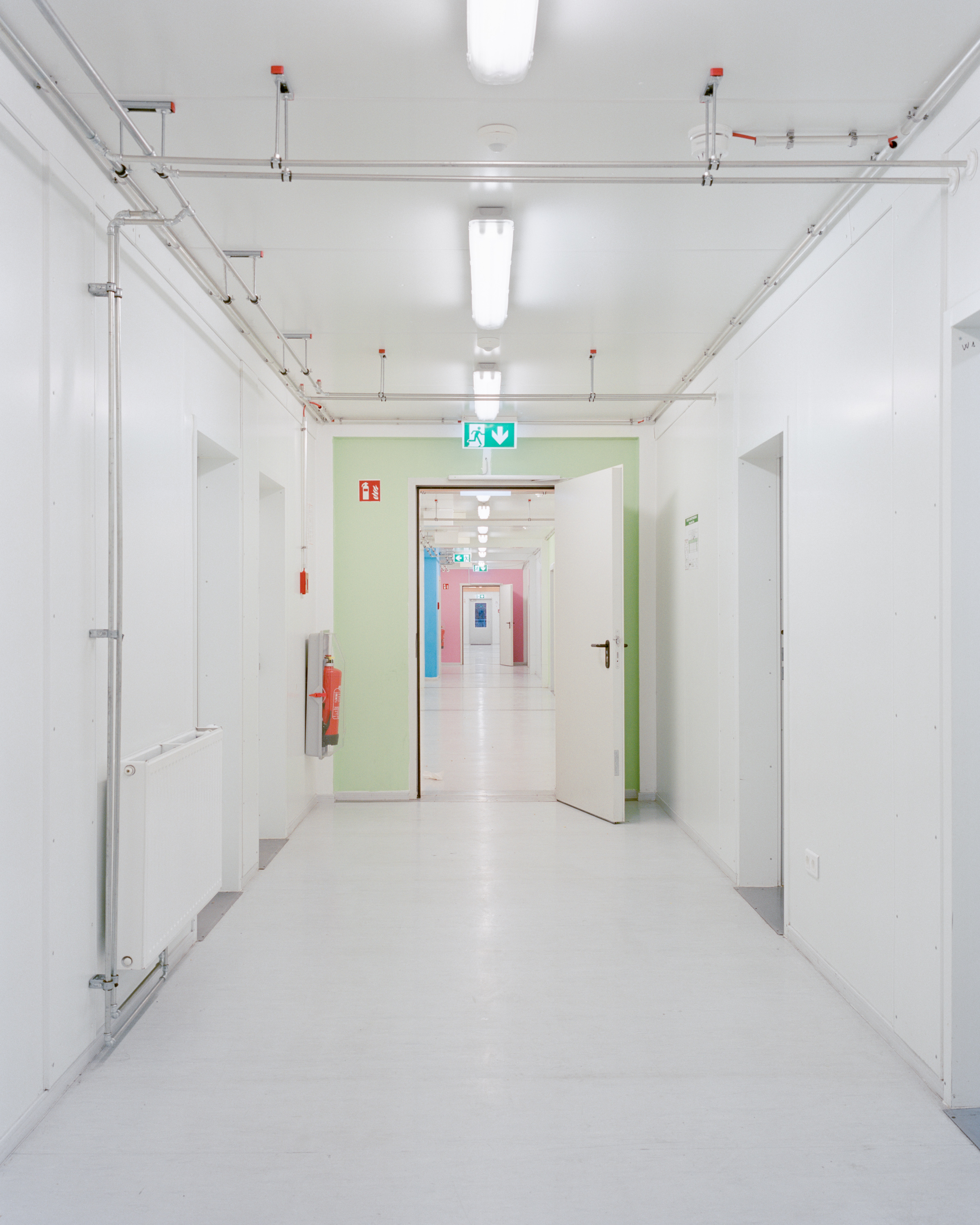 You see the hallway of a refugee accommodation. It is very similar to a hospital.